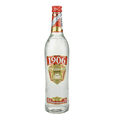 The Polmos Lublin 1906 Vodka 700ml features a clear glass bottle with a vintage red and gold label. The 1906 is highlighted, celebrating its quadruple distillation. With a smooth 40% alcohol content, it offers premium quality vodka at an economical price.